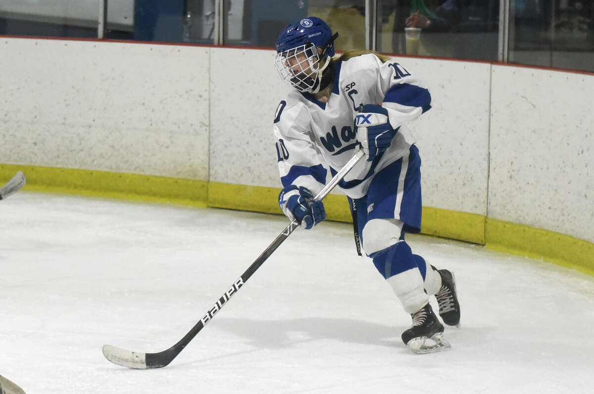 Darien's Kelsey Brown (10) skates with the puck against Stamford/Westhill/Staples during a girls ice hockey game at the Darien Ice House on Wednesday, Jan. 18, 2023.