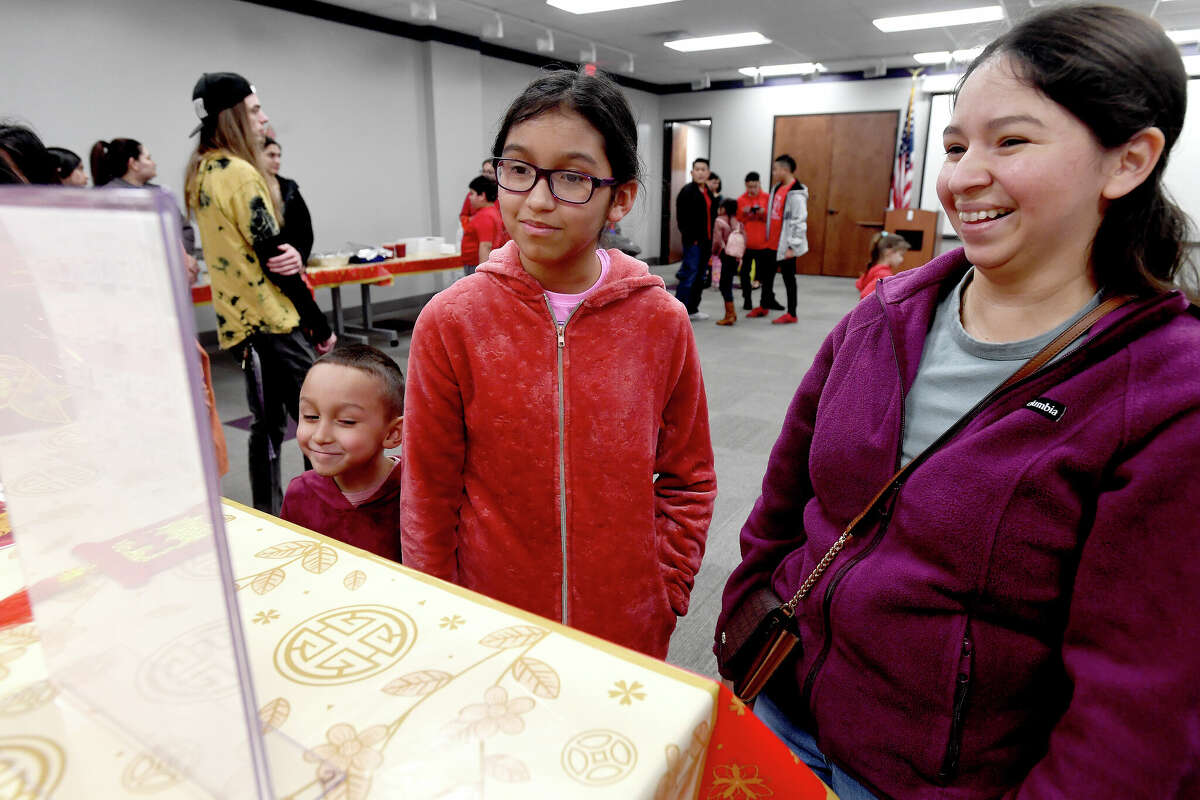 Yesenia Castaneda checks out her family's Lunar New Year animals with children Daisy and Joseph before The Flaming Lion Dancers perform at the Port Arthur Public Library, helping celebrate the Lunar New Year and 2023 as the "Year of the Rabbit." Photo made Monday, January 23, 2023 Kim Brent/Beaumont Enterprise