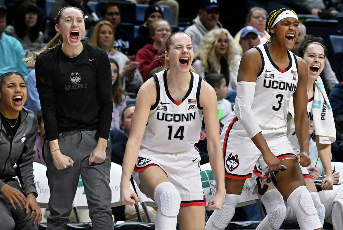 From left to right, UConn's Azzi Fudd, Paige Bueckers, Dorka Juhasz, Aaliyah Edwards and Lou Lopez-Senechal react from the bench in the second half of an NCAA college basketball game against DePaul, Monday, Jan. 23, 2023, in Storrs, Conn. (AP Photo/Jessica Hill)