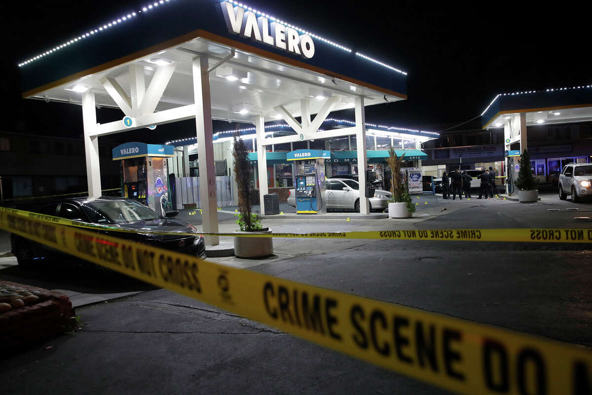 Oakland police investigate a multiple shooting and homicide at the Valero gas station on Seminary Avenue at MacArthur Boulevard in Oakland, Calif., on Monday, Jan. 23, 2023.