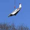 A lift helicopter airlifts the wreckage from a plane crash last week just across the Greenwich border in Armonk, N.Y. Tuesday, Jan. 24, 2023. Last Thursday, two Ohio residents were killed when their single-engine Beechcraft Bonanza A36 crashed off Rye Lake in Armonk, less than a mile from the Westchester County Airport.