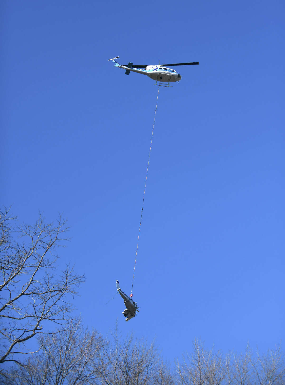 A helicopter airlifts the wreckage from a plane crash last week just across the Greenwich border in Armonk, N.Y. Tuesday, Jan. 24, 2023. Last Thursday, two Ohio residents were killed when their single-engine Beechcraft Bonanza A36 crashed off Rye Lake in Armonk, less than a mile from the Westchester County Airport.