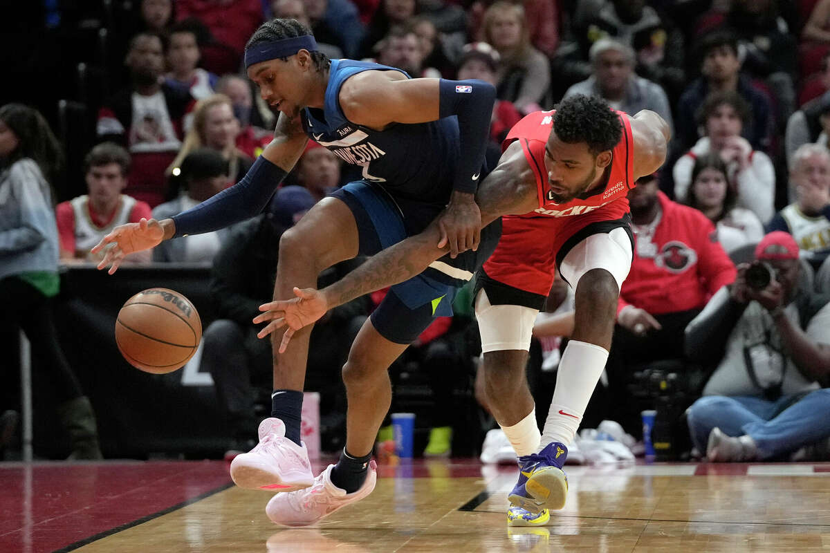 Houston Rockets' Tari Eason, right, tips the ball away from Minnesota Timberwolves' Jaden McDaniels during the second half of an NBA basketball game Monday, Jan. 23, 2023, in Houston.