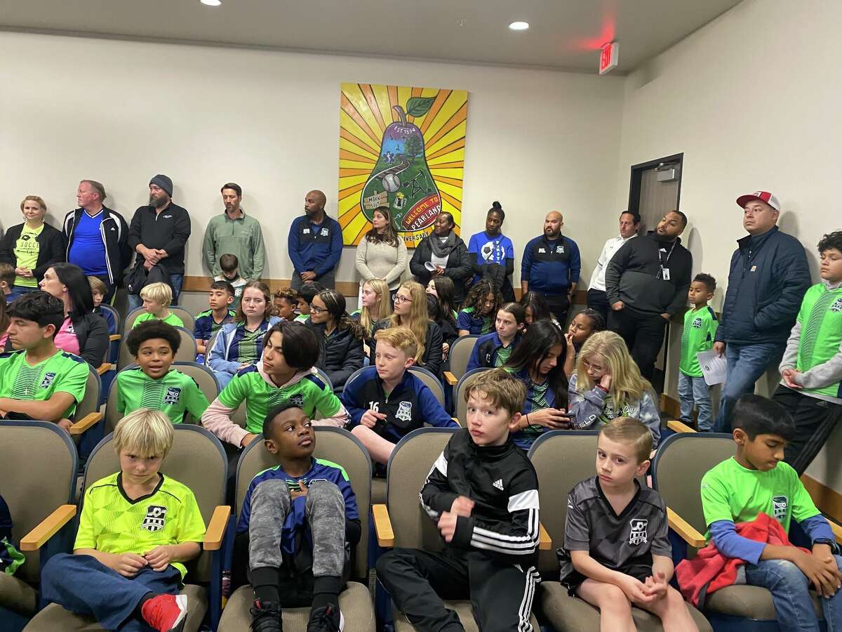 Children and parents from the Pearland Soccer League gathered at Monday's Pearland City Council meeting to pressure city officials to build more soccer fields. 