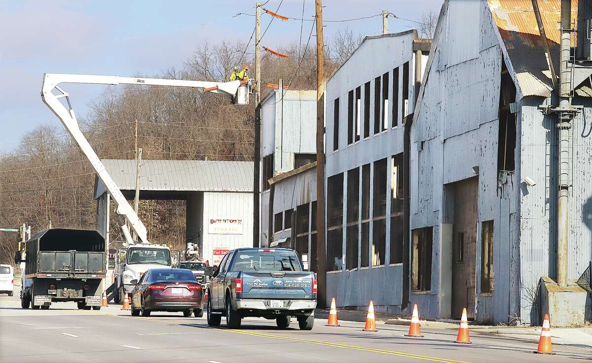 John Badman|The Telegraph Crews from Ameren disconnected power to the former metal tool and die company building Monday at 575 Piasa Street in downtown Alton in preparation for its demolition. 