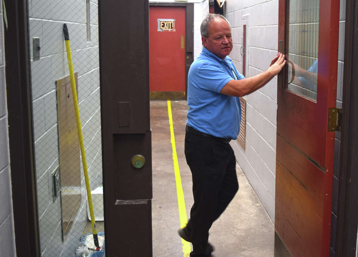 Sheriff Mike Carmody stands by the doors in a corridor of the Morgan County jail. Among upgrades approved this week will be the replacement of the doors to the corridors and cellblocks, which are part of the original construction in 1984.