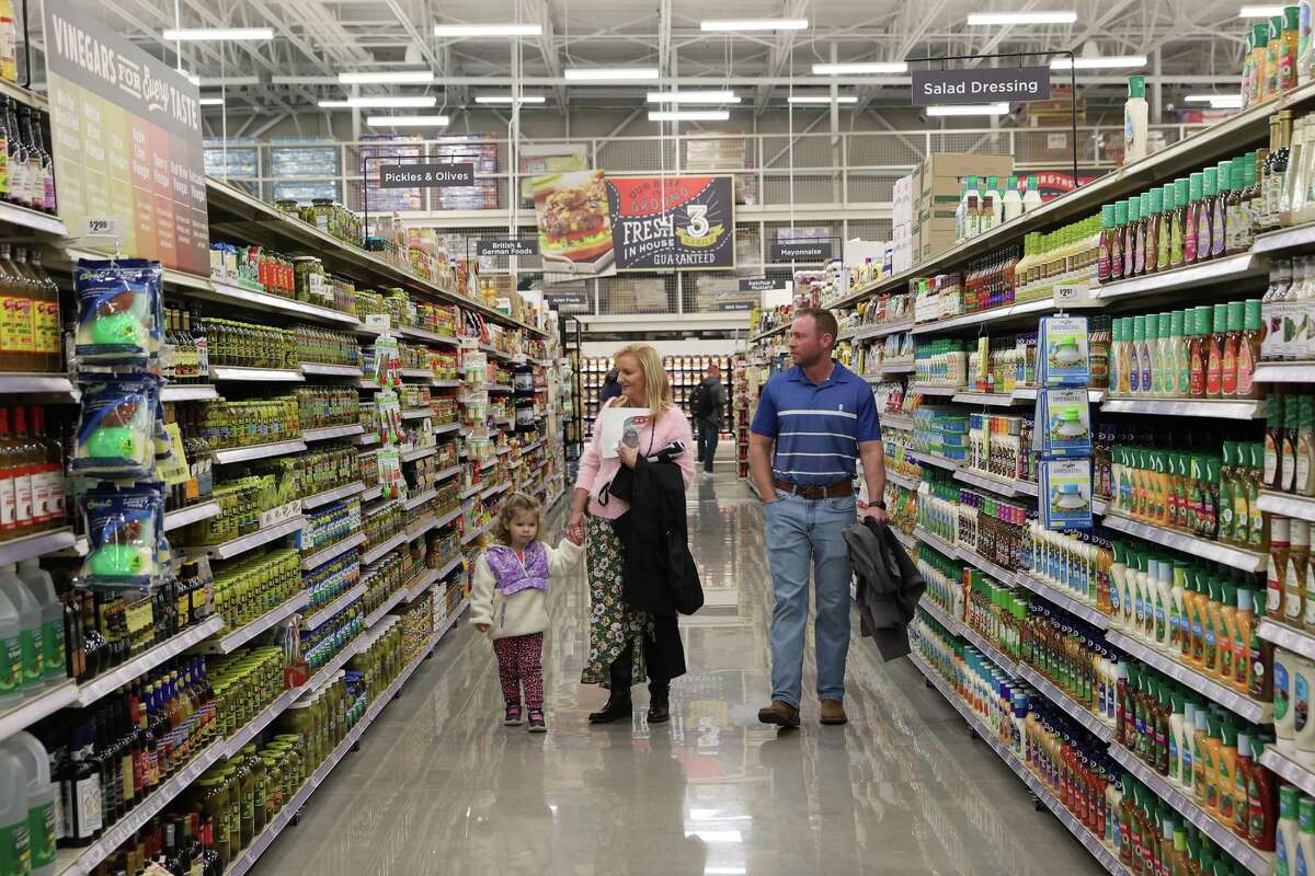 Brad Claus with his wife, Jeanine, and daughter, Ellie, 3, tour the new Cibolo H-E-B, Tuesday, Jan. 24, 2023. The 110,000 square-foot store is schedule to open to the public on Wednesday.
