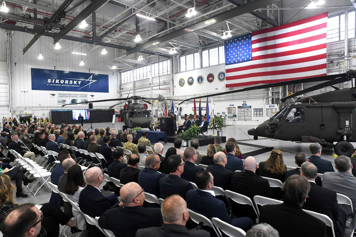 Sikorsky employees and visitors attend a delivery ceremony for the 5,000th Black Hawk helicopter, in Stratford, Conn., on Jan. 20, 2023. Sikorsky's parent company, Lockheed Martin, has announced plans to cut about 800 jobs in its rotary and mission systems division, which includes Sikorsky, but it has not provided details yet on the impact on Connecticut-based employees. Sikorsky has about 8,200 employees in Connecticut. 