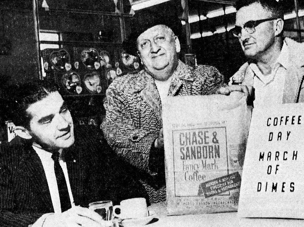 In preparation for the countywide Coffee Day to benefit the 25th anniversary of the March of Dimes drive, cochairs Irv Rhodea (right) and Bill Hanson (center) are shown delivering a supply of coffee to Newberry's yesterday, as store manager Dave Carlson looks on. The photo was published in the News Advocate on Jan. 31, 1963.