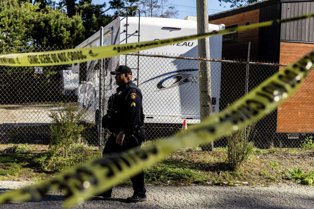 A San Mateo County Sheriff Deputy walks near a farm where a mass shooting took place in Half Moon Bay, Calif., on Monday. The act was rare in that the suspected gunman was a senior citizen — 66-year-old Chunli Zhao.