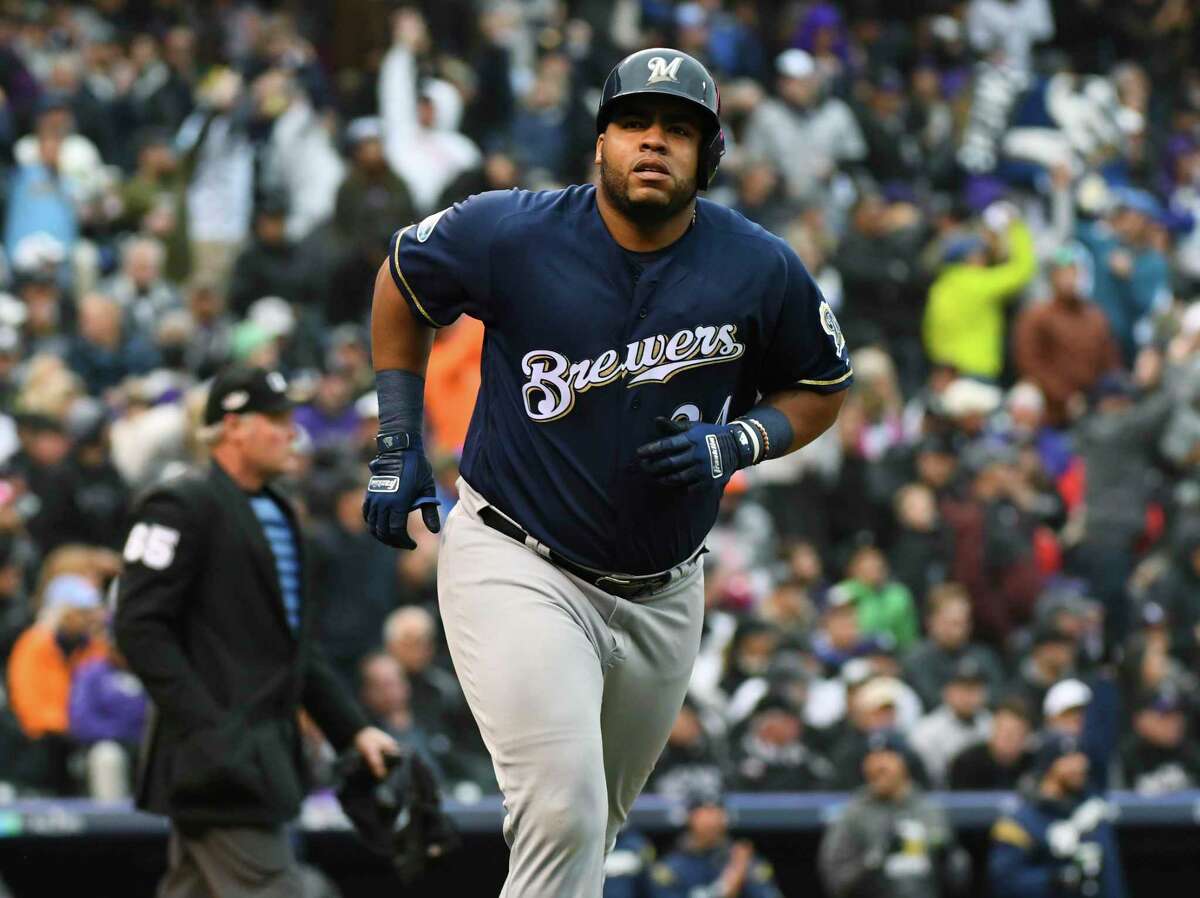 Milwaukee Brewers' Jesus Aguilar heads up the first base line after hitting a solo home run off Colorado Rockies starting pitcher German Marquez in the fourth inning of Game 3 of a baseball National League Division Series, Sunday, Oct. 7, 2018, in Denver. (AP Photo/John Leyba)