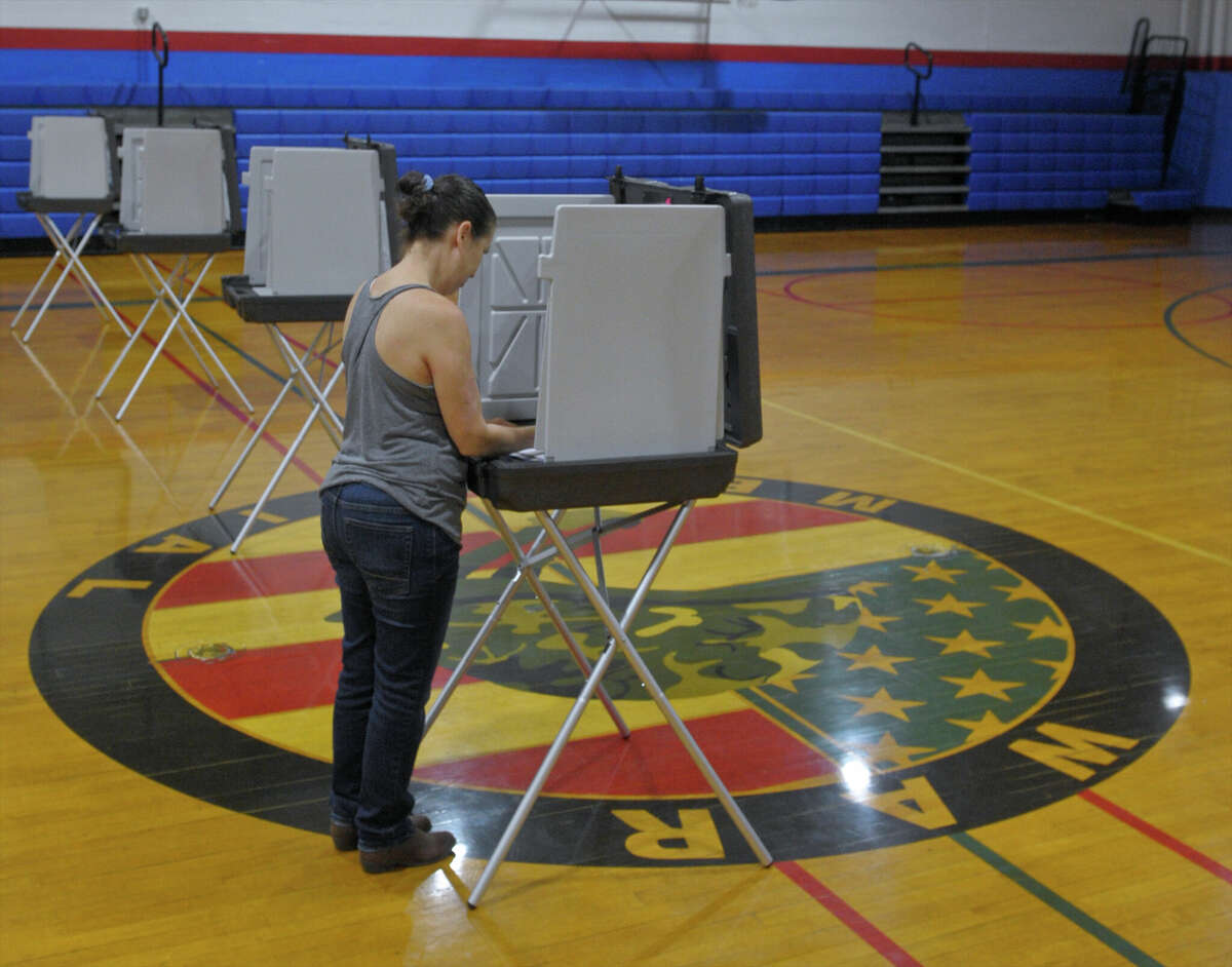 Kim Escobar, of Danbury, votes in the state primary in the 5th Ward in the War Memorial building in Danbury on August 14, 2018.