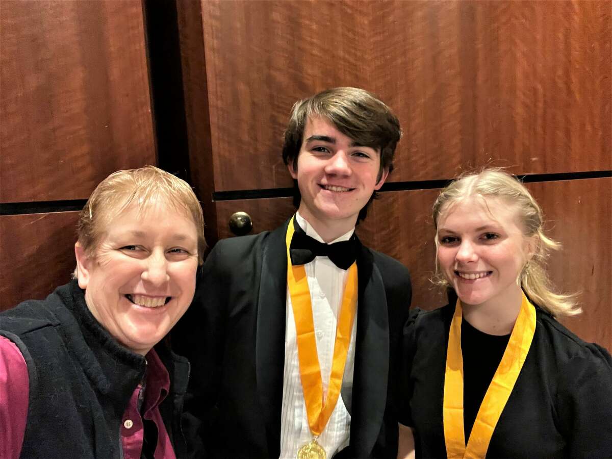 Andrea Mack (left), Manistee Area Public Schools director of bands, poses for a photo with All-State band students Jack O'Donnell and Sarah Huber.