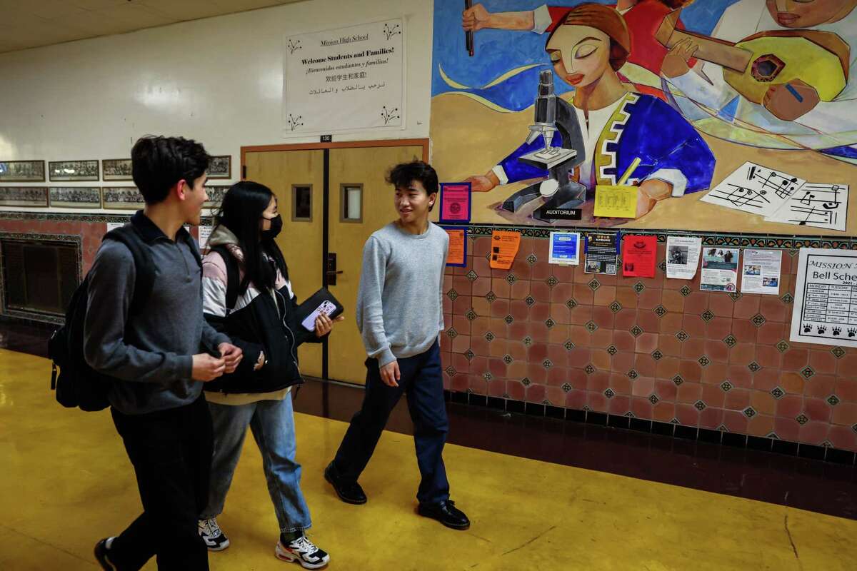 William Holder-Soto, 17 (left), Yixi Ou, 18, and Tuvana Soronzonbold, 17, walk to class at Mission High School in San Francisco.