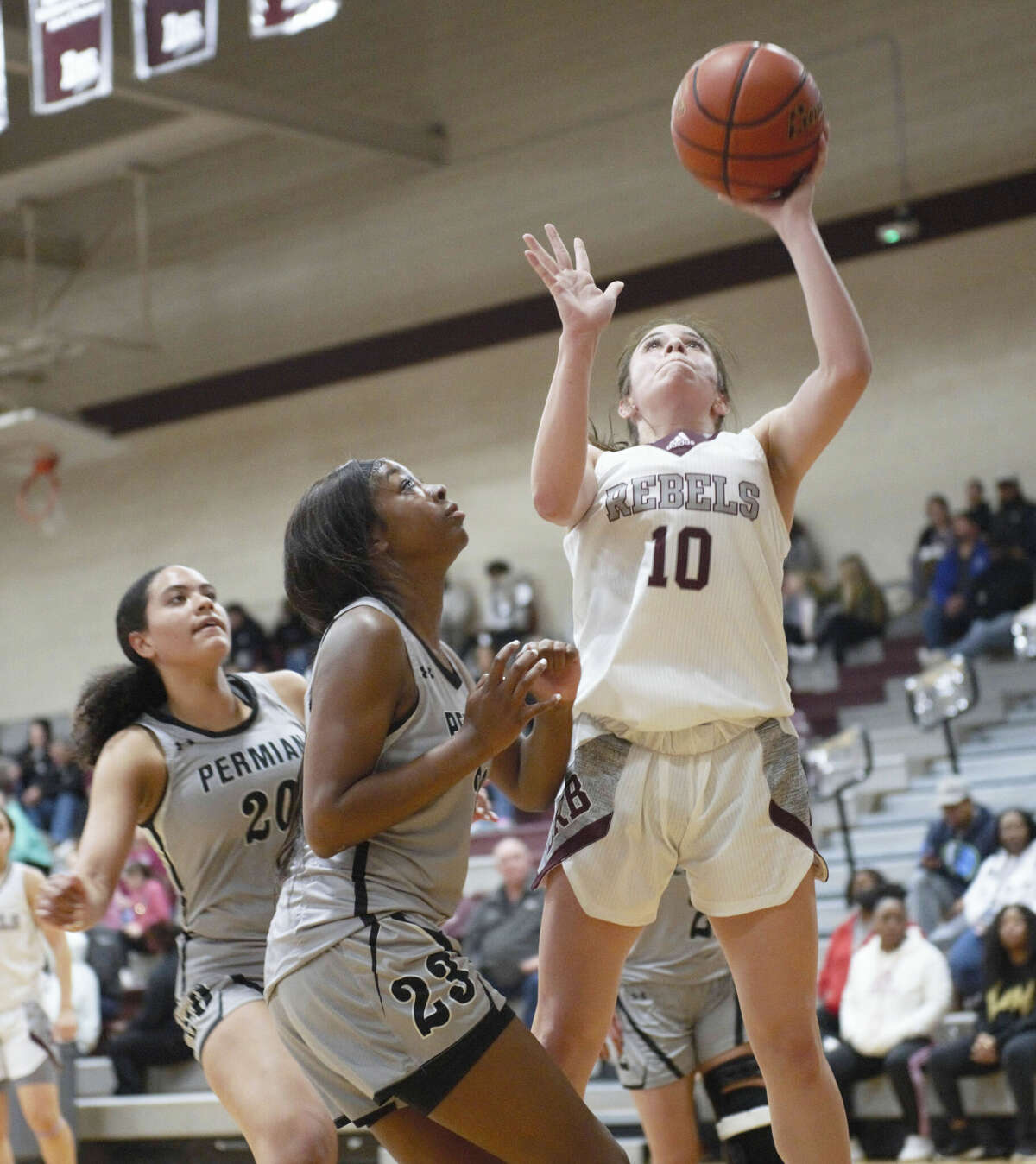 Legacy's Madyson Solis puts up a shot while being defended by Permian's Kimora Pierce (23) and Nadia Turner during a District 2-6A girls basketball game, Jan. 24 at Rebel Gymnasium. 