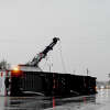 Workers get ready to remove a semi tractor-trailer that was blown on its side, blocking lanes on southbound TX 62/73 near Interstate 10, where a powerful tornado moved through the region Tuesday. The eastbound access road was also blocked by at least one other trailer blown on its side in the wake of the storm. Photo made Tuesday, January 24, 2023 Kim Brent/Beaumont Enterprise