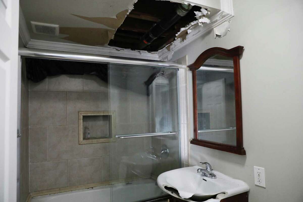 Squatters tore through the ceiling and broke the sink, among other damage to the home of Jennifer Sun and Ben Jiang.