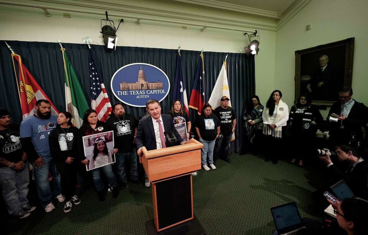 Family of those killed by a gunman at Robb Elementary School in Uvalde, Texas, and from the school shooting at Santa Fe, Texas, stand with Texas State Sen. Roland Gutierrez during a news conference at the Texas Capitol in Austin, Texas, Tuesday, Jan. 24, 2023. Gutierrez says he is filing legislation in the wake of Texas' rising gun violence.
