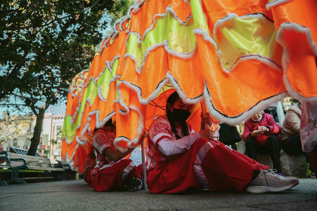Erica Lee waits to perform a dragon dance during the Lunar New Year celebration at Portsmouth Square in San Francisco, Calif., on Sunday, Jan. 22, 2022. For the Bay Area’s Asian Americans, two recent mass shootings mean vigils alongside celebrating 2023’s Lunar New Year.