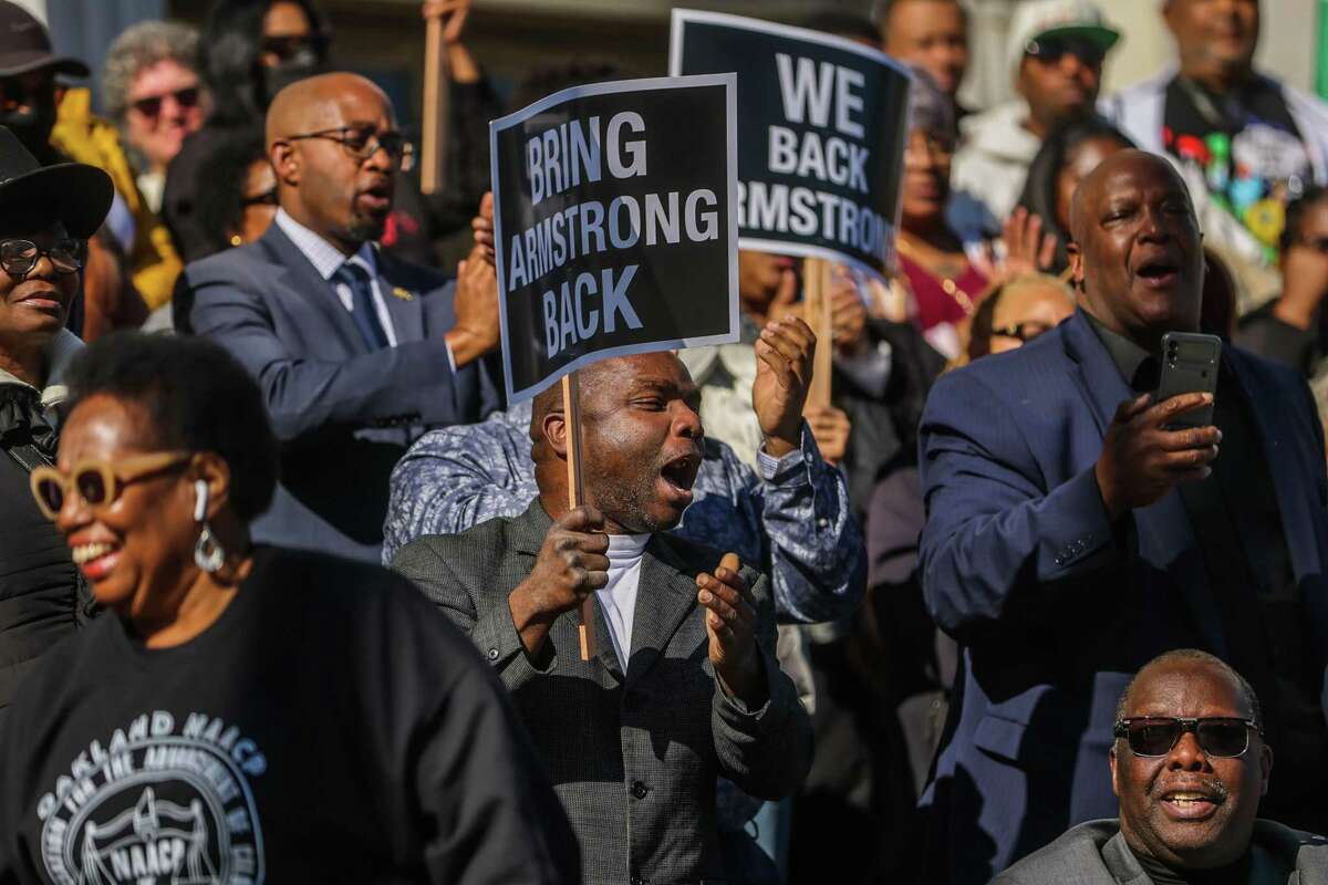 People cheer in support of Oakland police Chief LeRonne Armstrong during a press conference outside Alameda Superior Court in Oakland, Calif., on Tuesday, Jan. 24, 2023. A judge overseeing federal oversight of the department had harsh words during a hearing later that day.