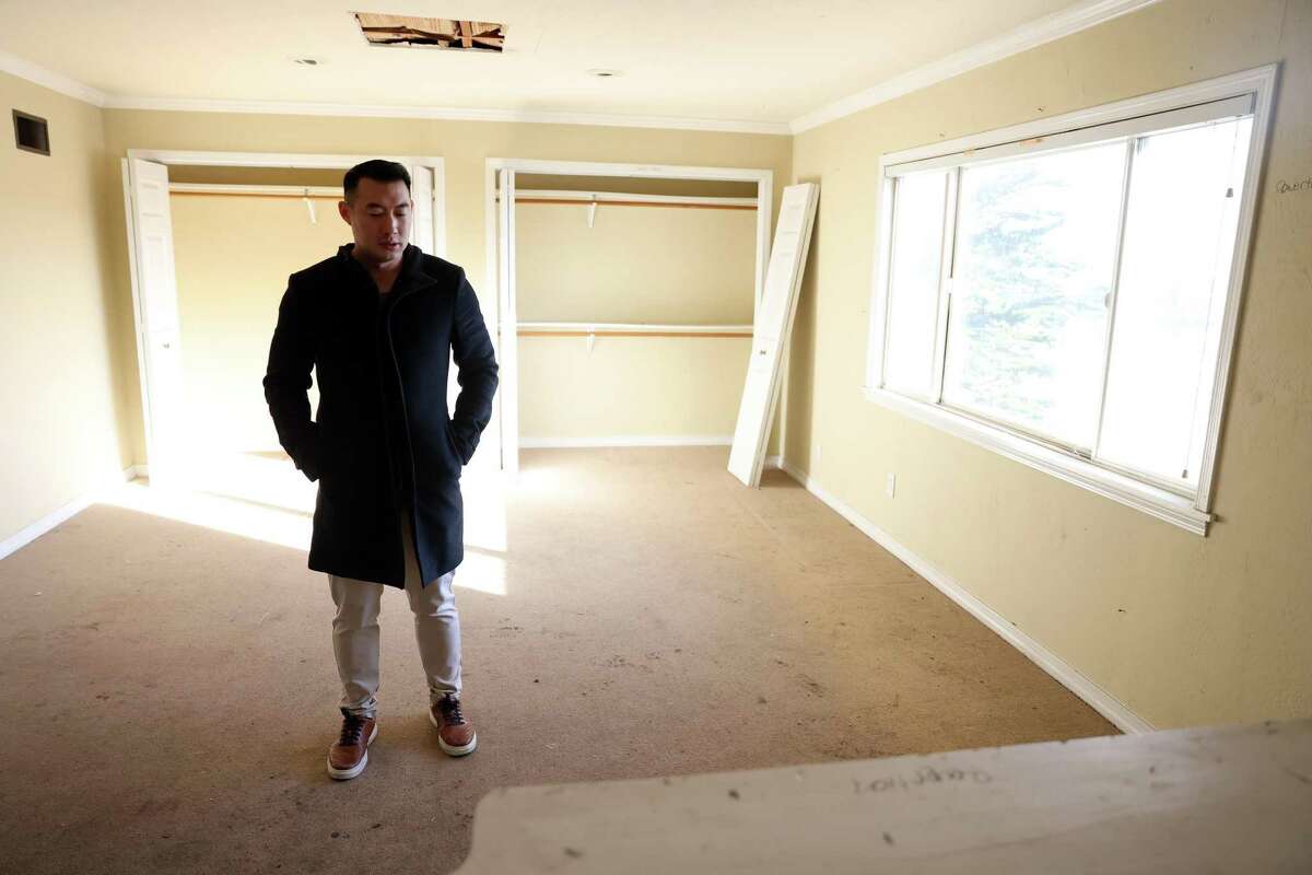 Ben Jiang stands in the Bernal Heights’ house that Jiang and his wife, Jennifer Sun, own in San Francisco. The city of San Francisco was extremely slow in permitting their remodel, and squatters took over the house and wrecked it.