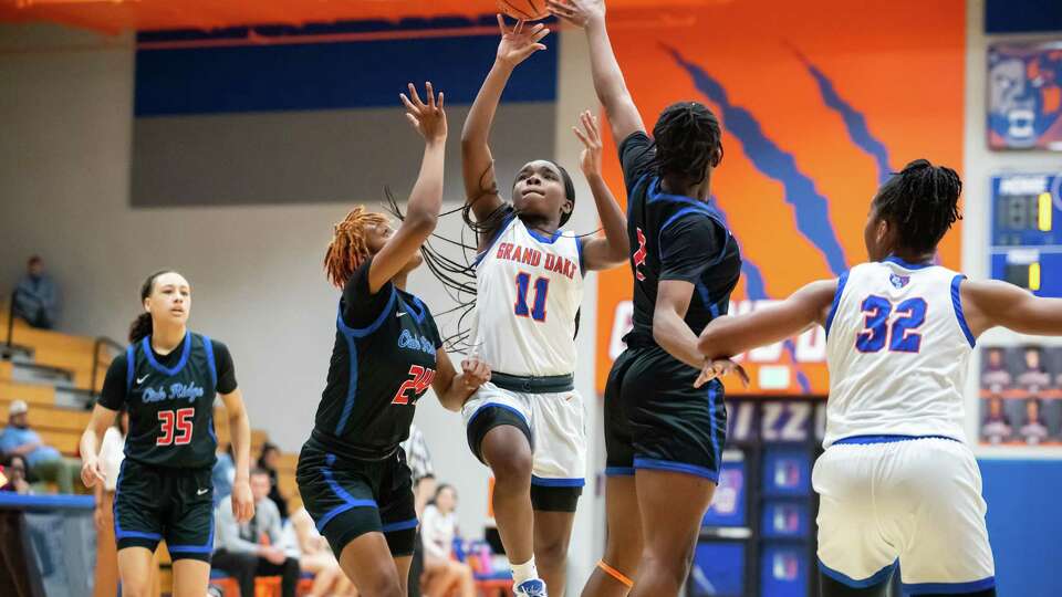 Grand Oaks guard Bree Riley (11) attempts a shot Oak Ridge guard Saniya Sherrod (24) in a district high school girlÕs basketball game Tuesday, Jan 24, 2023, in Spring.