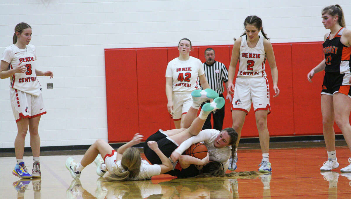 Benzie Central junior Marie Reidlinger (center) wrestles for a loose ball against Kingsley on Jan. 24, 2023 at Benzie Central Middle School. 