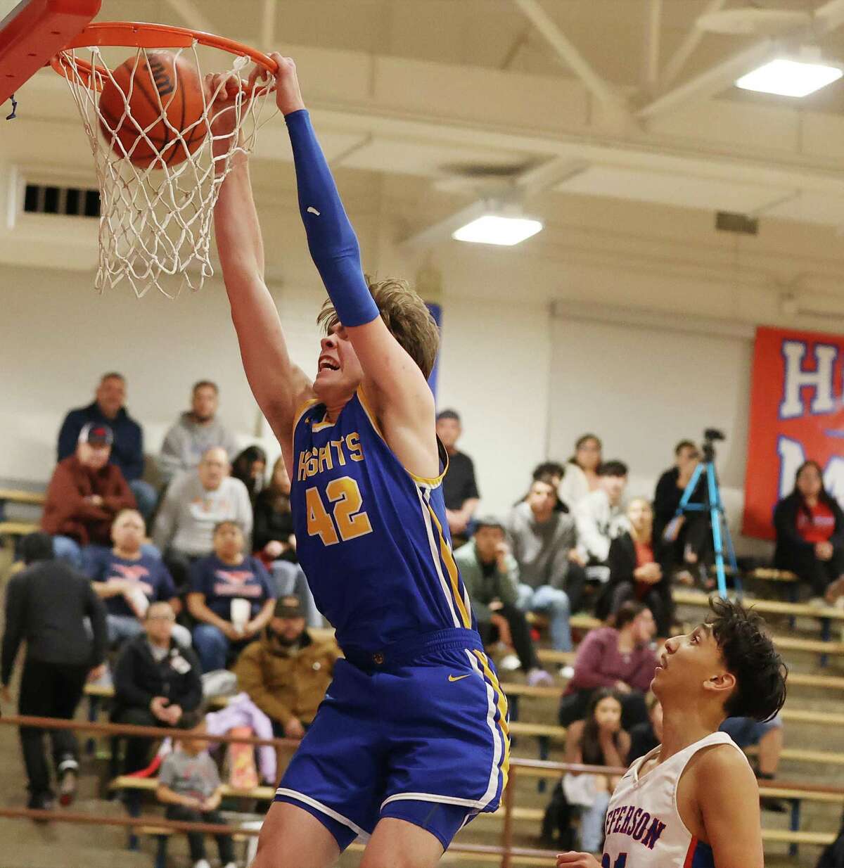 Alamo Heights’ Corbin Crocker dunks for two of his 12 points during Tuesday night’s 58-33 win at Jefferson.