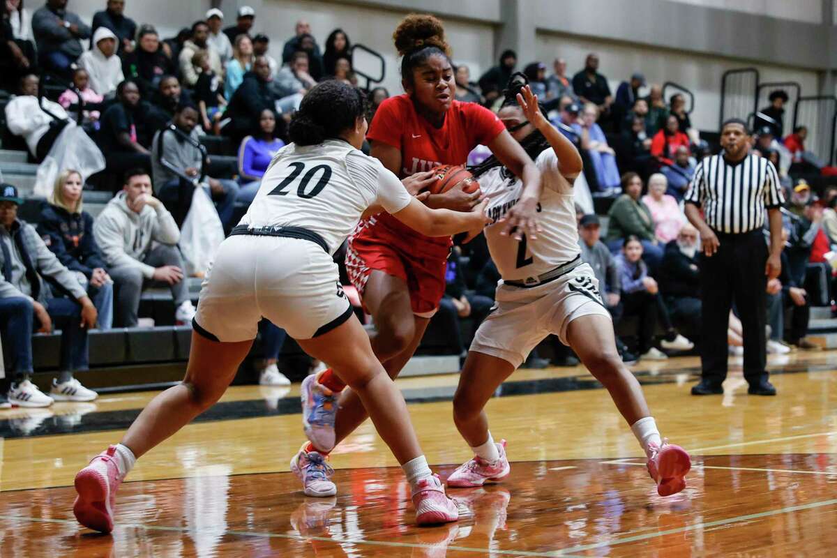 Judson’s Kayla King (5) drives through Steele defenders Adyson James (20) and Abriana Dandy (2) at Steele High School in Cibolo, Texas, Tuesday, Jan. 24, 2023. The Rockets defeated the Knights, 41-31.