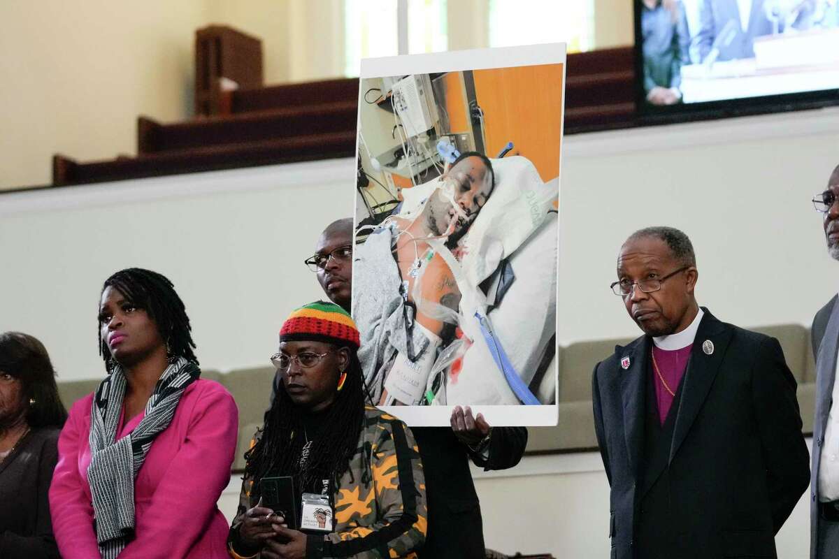 FILE - Family members and supporters hold a photograph of Tyre Nichols at a news conference in Memphis, Tenn., Jan. 23, 2023. The U.S. Attorney’s Office said Wednesday, Jan. 25, 2023 the federal investigation into the death of a Black man who died after a violent arrest by Memphis police “may take some time.” Speaking during a news conference, U.S. Attorney Kevin G. Ritz said his office is working with the Justice Department's Civil Rights Division in Washington as it investigates the case of Tyre Nichols, who died three days after his Jan. 7 arrest.