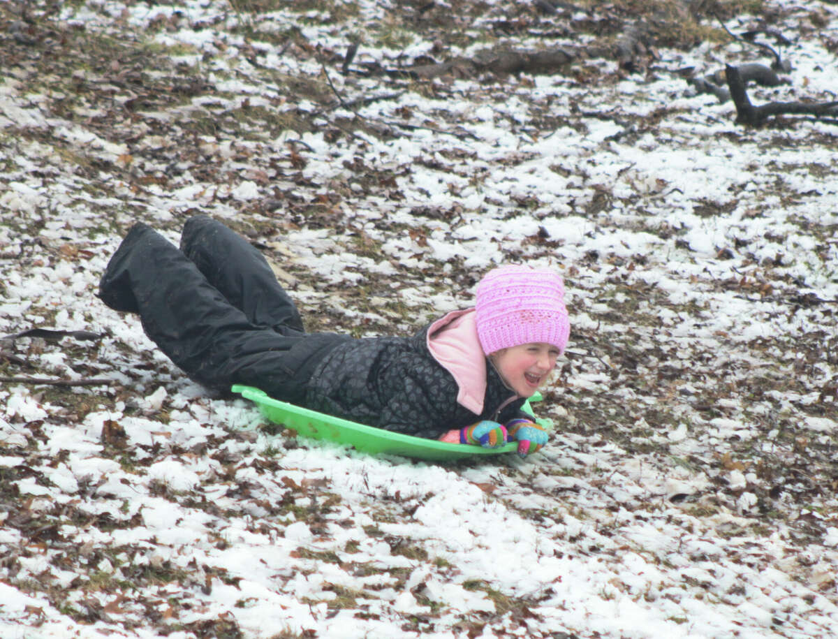 Amelia Diak sleds down the hill at Glen Carbon's Miner Park on Wednesday. 