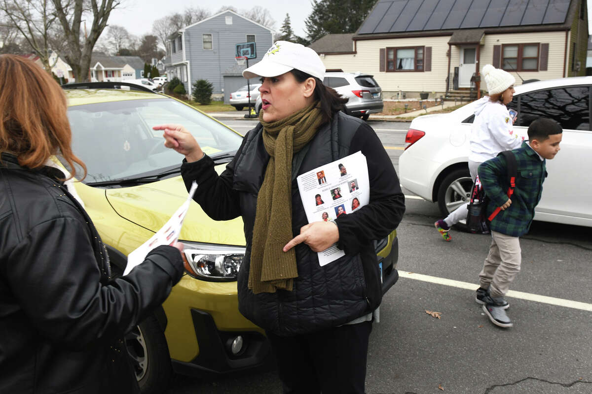 City Councilwoman Maria Pereira speaks with parents as they drop their kids off at the start of the day at Thomas Hooker School, in Bridgeport, Conn. Jan. 24, 2023. 