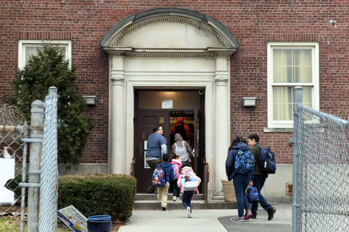 Students arrive for the start of the day at Thomas Hooker School, in Conn. Jan. 24, 2023.
