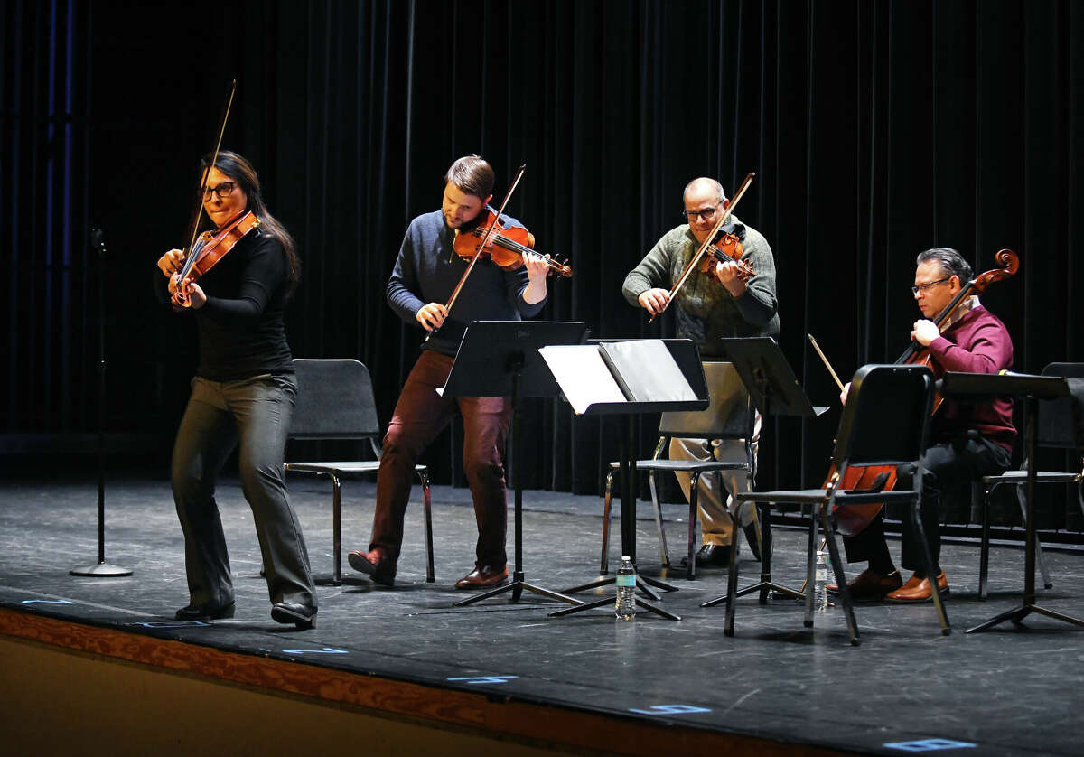The Dalí Quartet, from left, Adriana Linares, Ari Isaacman-Beck, Carlos Rubio, and Jesús Morales, perform an educational concert for elementary strings students at Darien High School in Darien, Conn. Wednesday, Jan. 25, 2023. The acclaimed quartet performed a skillful repertoire of Latin American classical pieces during an interactive and energetic show to a packed house of new strings players in grades three through five.