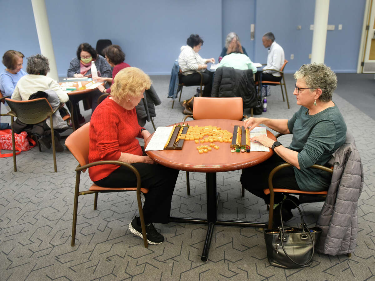 Stamford's Joan Wachowski, left, and Lorraine Iacovetta play a game together during the meeting of the mah-jongg club at the Ferguson Library Harry Bennett Branch in Stamford, Conn. Wednesday, Jan. 25, 2023. Dozens of players, ranging from beginners to experts, play the Chinese tile game from 11 a.m. to 1 p.m. every Wednesday.