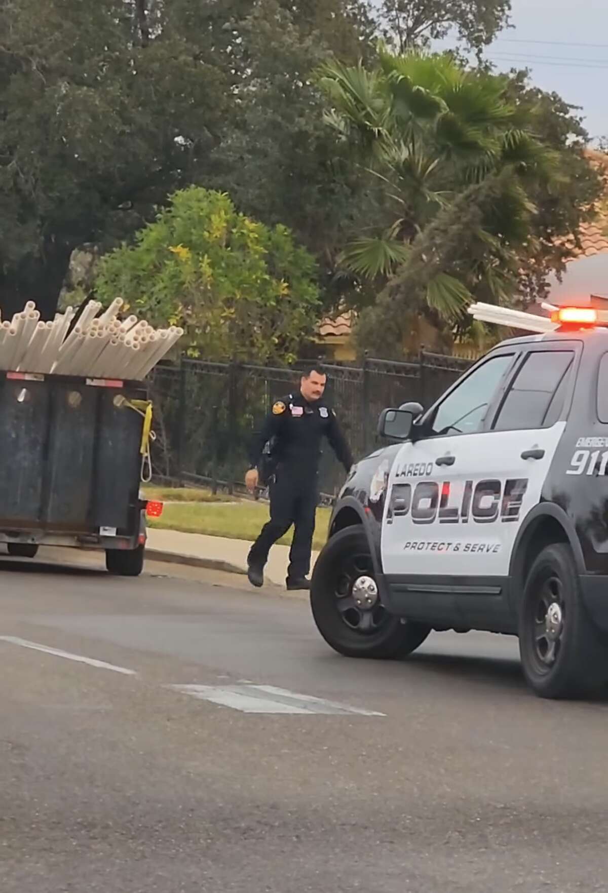 Laredo Police Department Office J. Garza is seen helping someone who had dropped some work materials on the side of the road. Olga Patricia Garza took video of the good deed on Monday Jan. 23, 2023.