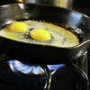 CHICAGO, ILLINOIS - JANUARY 12: In this photo illustration, eggs cook in a cast iron pan over flames on a natural gas-burning stove on January 12, 2023 in Chicago, Illinois. Consumers and politicians have voiced concern after the commissioner of the Consumer Product Safety Commission (CPSC) recently suggested that gas stoves were a health hazard, leading people to believe that they would be banned. (Photo Illustration by Scott Olson/Getty Images)