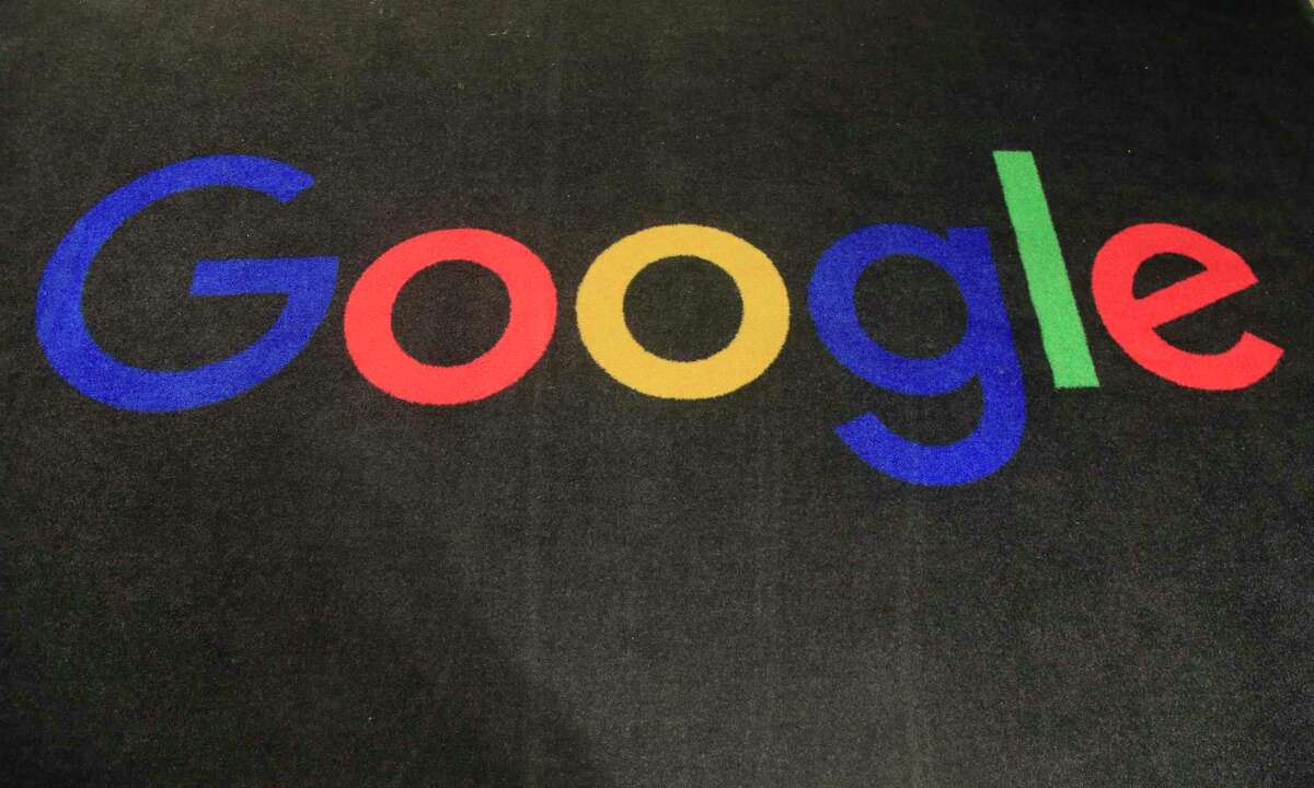 The logo of Google is displayed on a carpet at the entrance hall of Google France in Paris. Google said it’s laying off 12,000 workers, becoming the latest tech company to trim staff after rapid expansions during the COVID-19 pandemic have worn off.
