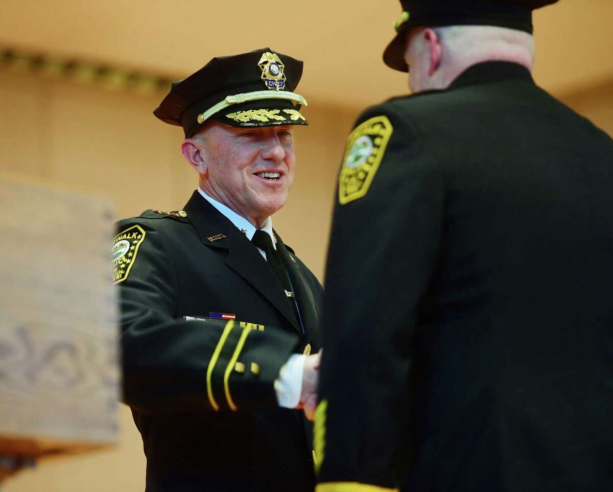New Norwalk Police Chief James Walsh, left, shakes hands with newly promoted Deputy Chief Terrance Blake during a promotion ceremony at City Hall in Norwalk, Conn. on Wednesday, January 25, 2023.