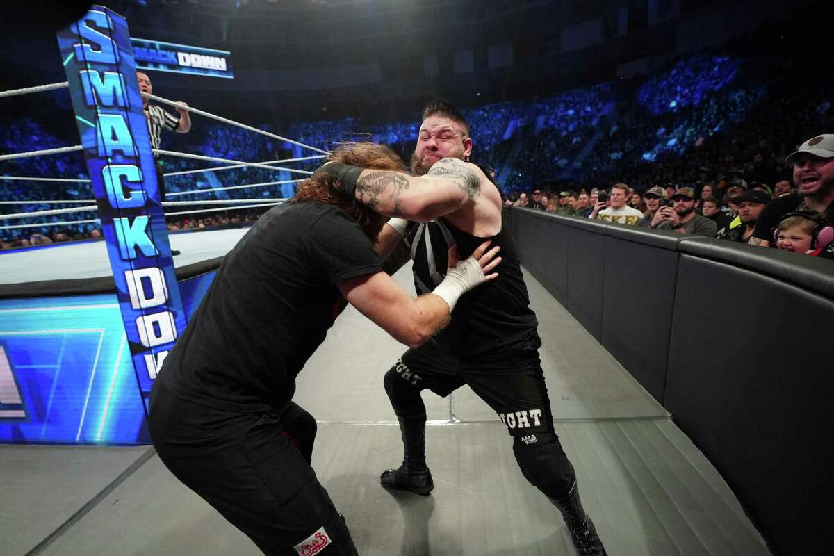 Kevin Owens, left, grapples with Sami Zayn outside the ring on Smackdown. The longtime friends are now on opposite side of a feud in one of the WWE’s hottest storylines in years.