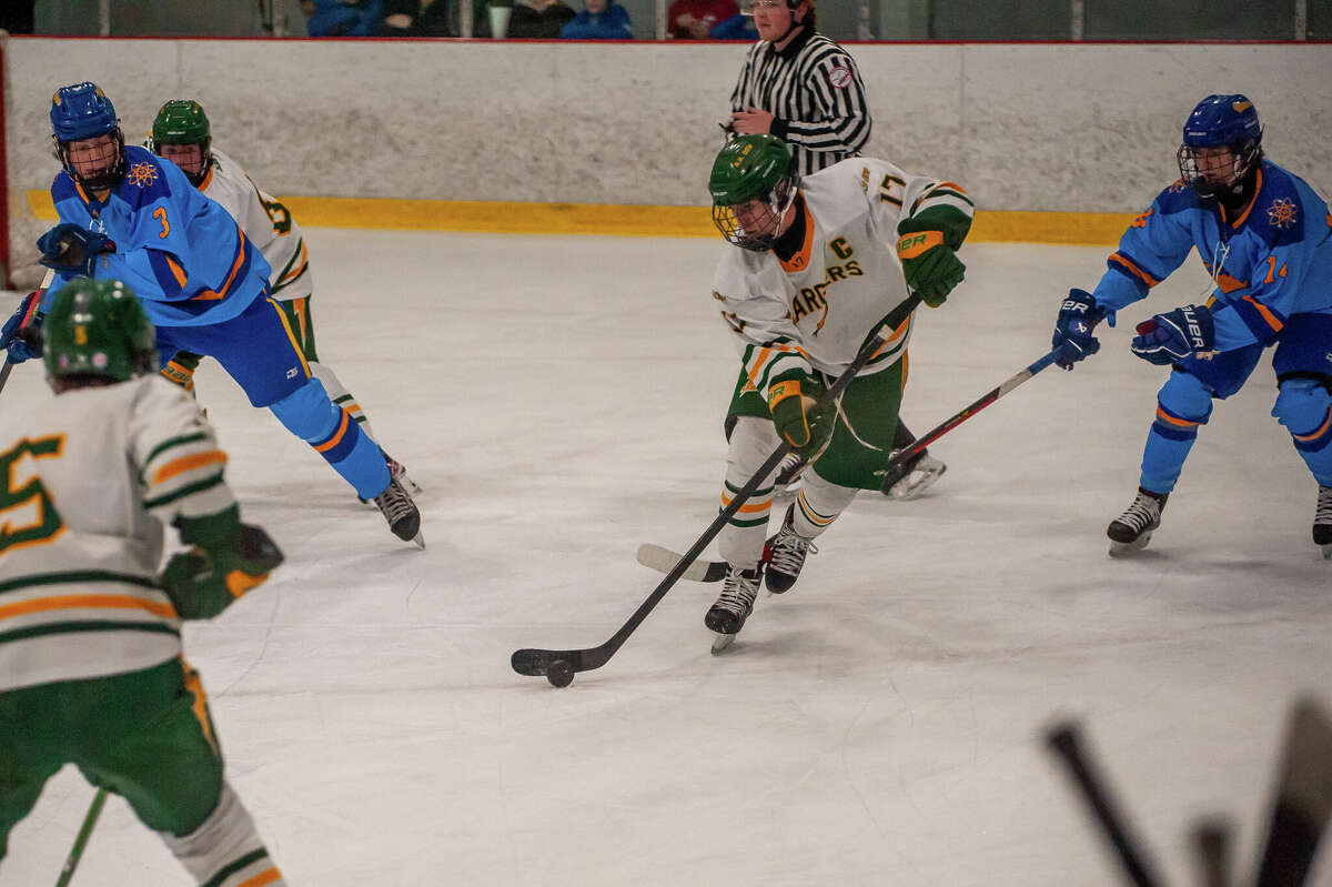 Dow and Midland high hockey players face off in a rivalry game on Jan.  25, 2023 at the Midland Civic Arena.