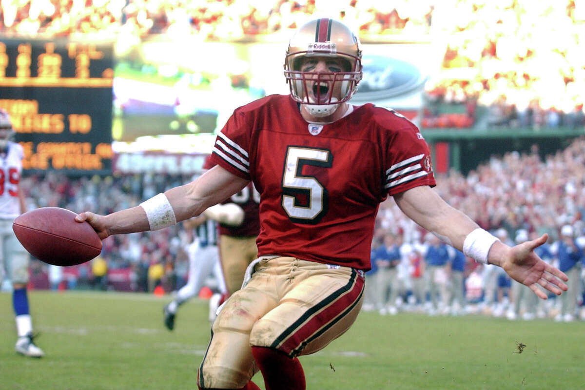 Quarterback Jeff Garcia celebrates after scoring a touchdown against the New York Giants in the NFC Wild Card game on Jan. 5, 2003.