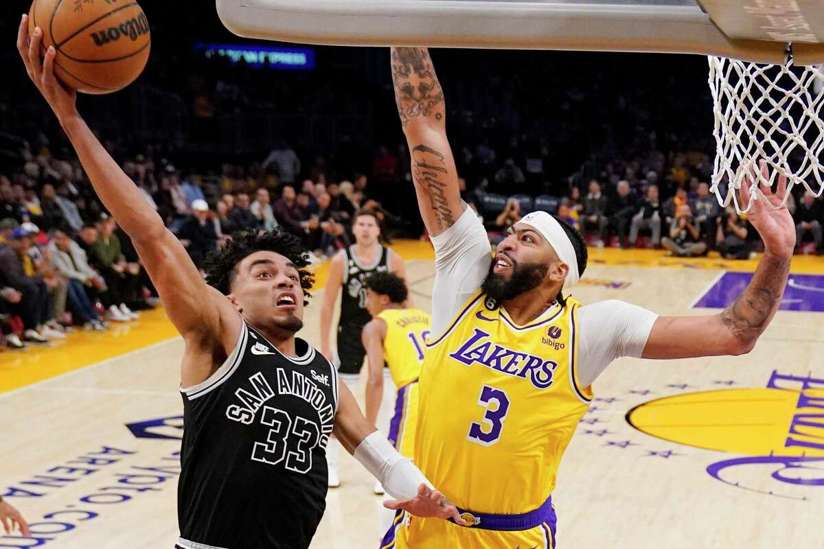 Spurs guard Tre Jones, left, shoots as Los Angeles Lakers forward Anthony Davis defends during the first half of Wednesday’s game in Los Angeles.