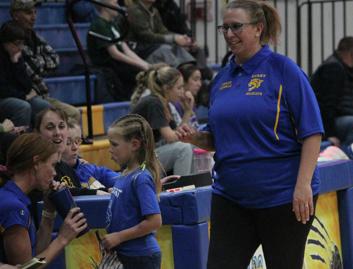 Evart coach Carrie Kunkle (right) walks to her coaching position during action earlier this season. Kunkle's Wildcats, ranked No. 4 in Division 3, fell to Lake City on Wednesday.
