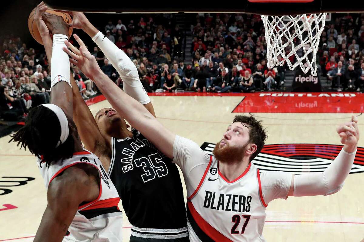 PORTLAND, OREGON - JANUARY 23: Jerami Grant #9 and Jusuf Nurkic #27 of the Portland Trail Blazers block the shot of Romeo Langford #35 of the San Antonio Spurs during the second quarter at Moda Center on January 23, 2023 in Portland, Oregon. NOTE TO USER: User expressly acknowledges and agrees that, by downloading and/or using this photograph, User is consenting to the terms and conditions of the Getty Images License Agreement. (Photo by Steph Chambers/Getty Images)