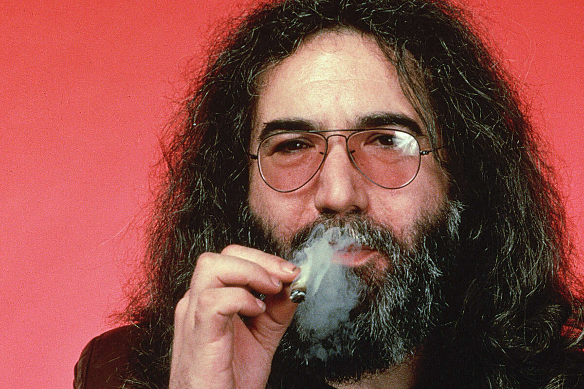 Jerry Garcia, guitarist and singer for the rock group the Grateful Dead, smokes a marijuana cigarette.