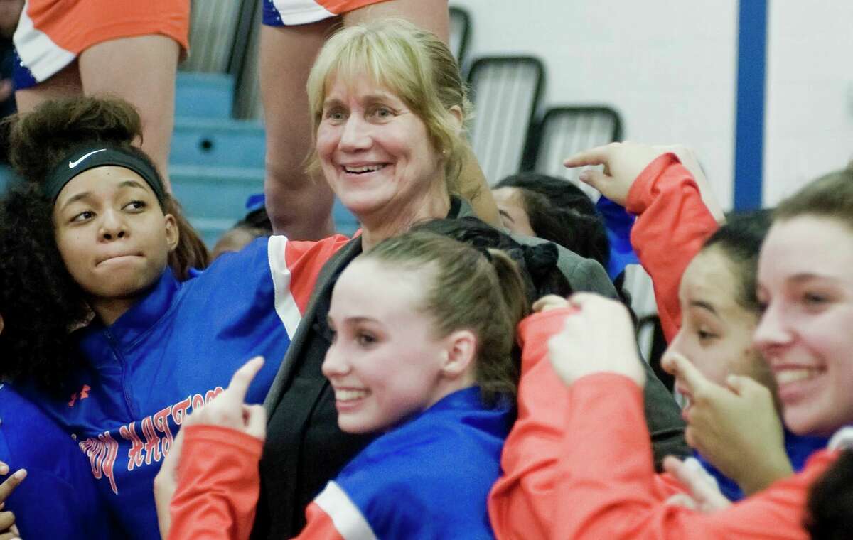 Danbury High School girls basketball Head Coach Jackie DiNardo celebrates with her team after her 500th victory in a game against Bridgeport Central High School, played at Danbury. Tuesday, Feb. 5, 2019