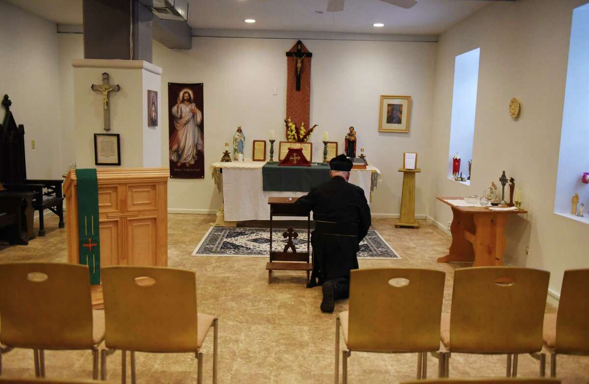 Father Richard Russo kneels before the alter at his new chapel on Thursday, Jan. 26, 2023, at St. Helen Parish Mercy Center in Ballston Spa, N.Y.