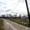Downed power lines lie across Garrison Rd., which suffered catastrophic damage to multiple homes. Photo made Wednesday, January 25, 2023 Kim Brent/Beaumont Enterprise