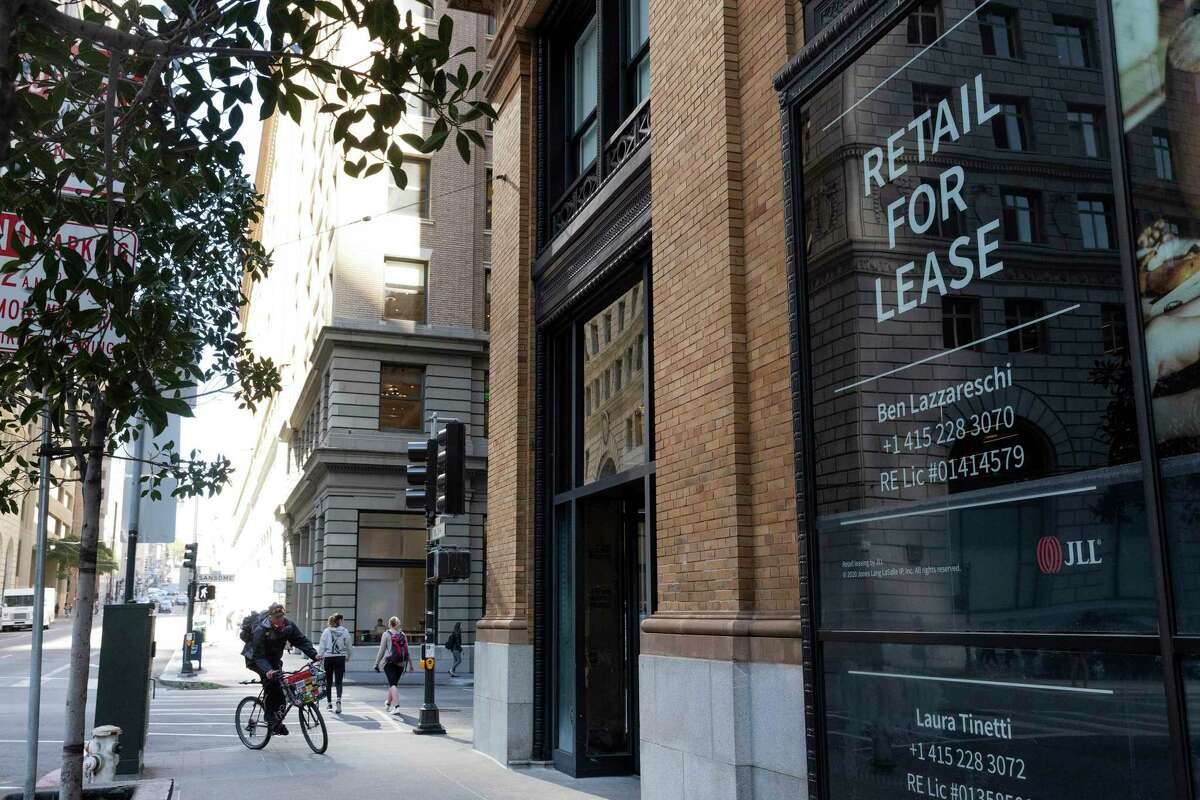 A cyclist rides past a building for lease on the corner of Sansome and Bush streets in San Francisco last May.